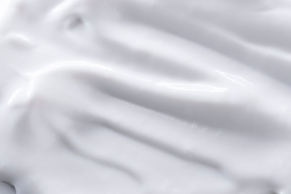 A detailed close-up of a smooth white cream texture, perfect for backgrounds or food image