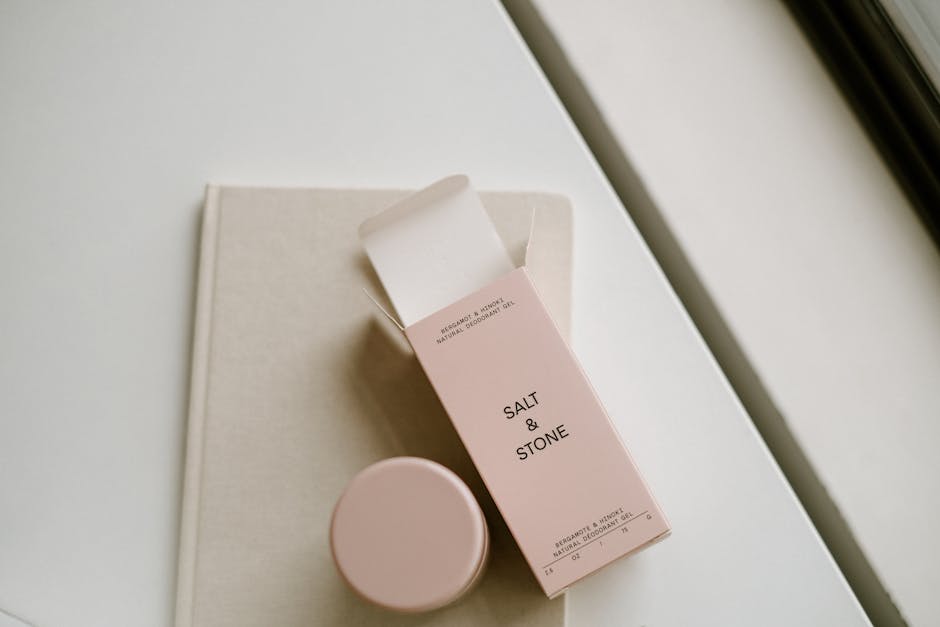 Elegant flat lay of natural deodorant packaging with muted tones and clean design.