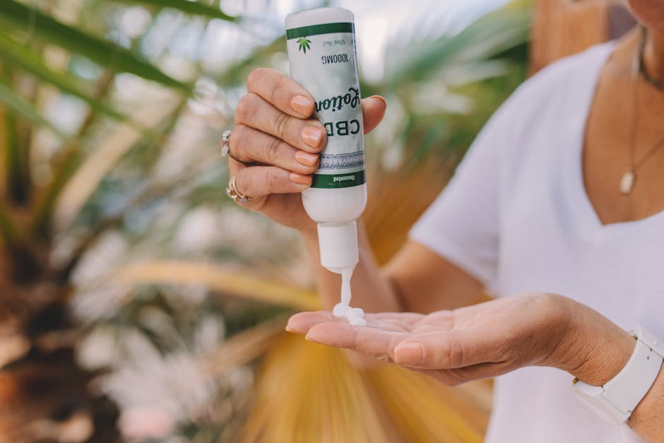 Hand applying CBD lotion outdoors, promoting relaxation and skincare benefits.