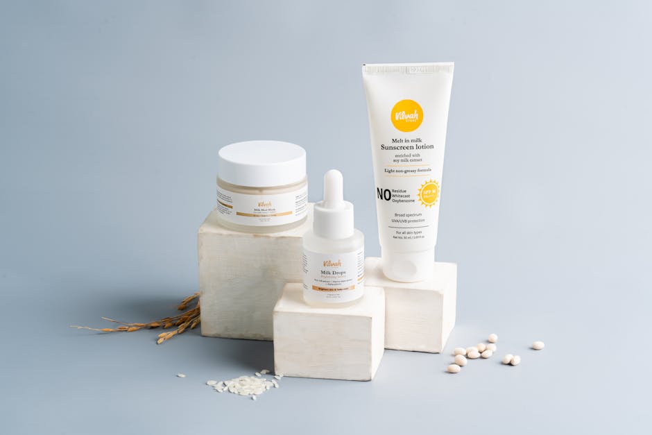 Elegant skincare and sunscreen products on a gray backdrop. Ideal for beauty marketing.